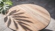 © mamo studios - Modern, minimal teak wood table round smooth beautiful grain podium table, green tropical tree in sunlight, leaf shadow on blank concrete floor for luxury organic cosmetic, skincare, beauty, food prod