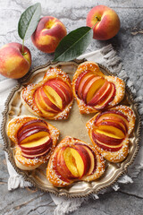 Canvas Print - Festive peach puff in the shape of a heart with fresh fruit and jam close-up in a plate on the table. Vertical top view from above