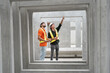 © chachamp - Portrait happy caucasian engineer man working with Hispanic Latin engineer man at precast cement outdoor factory