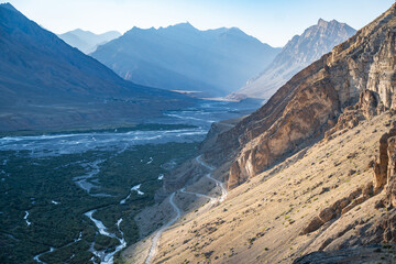 A river flows through a valley with mountains in the distance, Spiti Valley, India