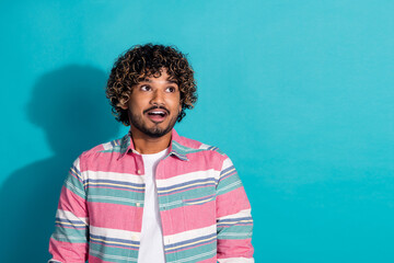 Wall Mural - Photo of cheerful nice latin man wear trendy striped clothes look empty space isolated on cyan color background