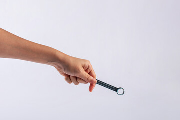 Wall Mural - Hand holding a wrench isolated on white background.