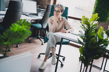 Poster - Photo of happy charming senior lady assistant wear formal shirt working indoors workshop workstation loft