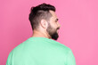 © deagreez - Side profile rear view photo of cheerful guy with beard dressed green t-shirt look at sale empty space isolated on pink color background