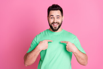 Sticker - Photo of impressed good mood nice guy with stylish beard dressed green t-shirt indicating at himself isolated on pink color background