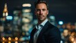 © Antonio - Confident businessman in a sleek suit standing against a vibrant city nightscape, exuding sophistication and success.