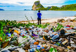 © STOCK PHOTO 4 U - Environmental Pollution: Man Standing on Beach with Pile of Plastic Waste and Scenic Mountain View