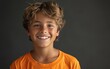 © FMSTUDIO - Young Boy With Blonde Hair Smiling Against Grey Background