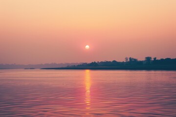 Wall Mural - A serene sunset scene with a body of water in the background, perfect for use in travel or nature-themed contexts