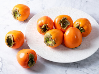 Poster - ripe persimmon on a plate