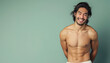 © Alienmonster Images - Smiling Shirtless Man with Defined Abs and Long Hair Against a Subtle Green Background for Healthy Lifestyle Advertisement