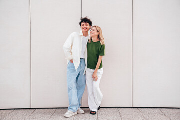 Sticker - Smiling beautiful woman and her handsome boyfriend. Couple in casual summer clothes. Happy cheerful family. Female and man having fun. They posing in the street in sunny day. Having tender moments