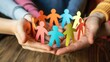 © Summit Art Creations - Hands holding a chain of colorful paper cut-out people. Close up of diverse people holding colorful doll holding hands together. Teamwork. Community and teamwork concept for design and print. AIG53F.