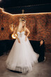© Roman - young beautiful caucasian blonde girl holding another wedding dress, choosing wedding dress in bridal salon, preparing to wedding, choose wedding dress concept