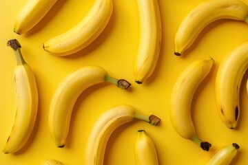 Wall Mural - Fresh bananas on vibrant yellow background, top view flat lay concept for healthy eating and nutrition inspirations