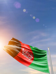 Afghanistan national flag aerial view clouds in beautiful sky. Top view. Drone. Aerial bird's eye fly flag. Aerial top flag view cloudscape.  Flag with Sunrise or sunset over clouds.