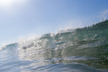 Wall Mural - Small wave breaking on the beach shore.