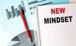 © Iryna - NEW MINDSET text on notebook on chart background