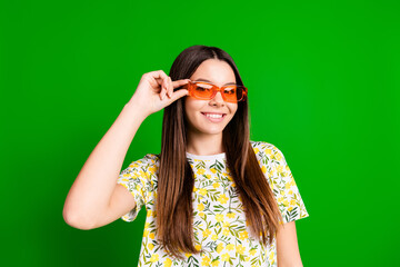 Sticker - Photo portrait of attractive teen woman touch sunglass dressed stylish flowers print clothes isolated on green color background