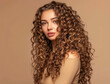 © Jarmila - Curly haired woman with long hair in studio on beige background, high detail, high resolution photography