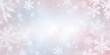 © Kromstar Studios - Soft pink and white copy space over a winter background with blurred snowflakes
