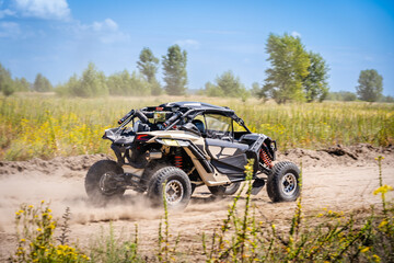 Wall Mural - UTV buggy moves on dusty road. 4x4, extreme, adrenalin.