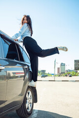 Wall Mural - A girl sits on a car wheel.