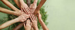 © Lahiru - A group of diverse people holding their hands together for volunteer tree plantation team work. Charity or volunteer support, multi-ethnic and multicultural, charitable organization concept.