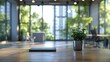 © Barosanu - A closed laptop sits alongside a small green plant on an office table, set in a bright, open office space with large windows and lush green surroundings.