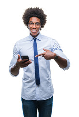 Canvas Print - Afro american business man texting using smartphone over isolated background very happy pointing with hand and finger