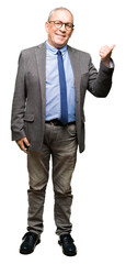 Poster - Handsome senior businesss man wearing glasses and tie smiling with happy face looking and pointing to the side with thumb up.