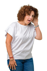 Sticker - Beautiful middle ager senior woman wearing white t-shirt over isolated background smiling with hand over ear listening an hearing to rumor or gossip. Deafness concept.