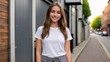 © QuoDesign - Teenage girl wearing white t-shirt and grey jeans standing in a city alley