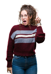 Canvas Print - Beautiful brunette curly hair young girl wearing glasses over isolated background pointing finger up with successful idea. Exited and happy. Number one.