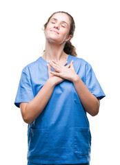 Sticker - Young brunette doctor girl wearing nurse or surgeon uniform over isolated background smiling with hands on chest with closed eyes and grateful gesture on face. Health concept.