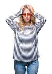 Sticker - Beautiful young blonde woman wearing sunglasses over isolated background suffering from headache desperate and stressed because pain and migraine. Hands on head.