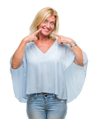 Sticker - Middle age blonde business woman over isolated background smiling confident showing and pointing with fingers teeth and mouth. Health concept.