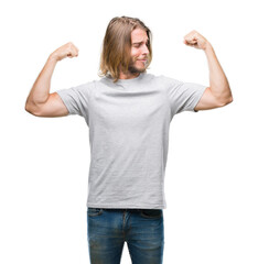 Sticker - Young handsome man with long hair over isolated background showing arms muscles smiling proud. Fitness concept.