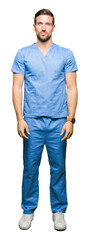 Poster - Handsome doctor man wearing medical uniform over isolated background with serious expression on face. Simple and natural looking at the camera.