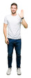 © Krakenimages.com - Handsome man wearing casual white t-shirt Waiving saying hello happy and smiling, friendly welcome gesture