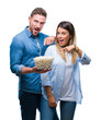 © Krakenimages.com - Young couple in love eating popcorn over isolated background very happy pointing with hand and finger