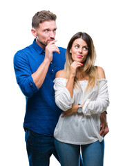 Poster - Young couple in love over isolated background with hand on chin thinking about question, pensive expression. Smiling with thoughtful face. Doubt concept.