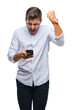 © Krakenimages.com - Young handsome man texting using smartphone over isolated background annoyed and frustrated shouting with anger, crazy and yelling with raised hand, anger concept