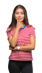 Sticker - Young beautiful arab woman over isolated background looking confident at the camera with smile with crossed arms and hand raised on chin. Thinking positive.