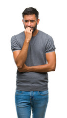 Canvas Print - Adult hispanic man over isolated background looking stressed and nervous with hands on mouth biting nails. Anxiety problem.