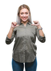 Wall Mural - Young blonde business woman over isolated background looking confident with smile on face, pointing oneself with fingers proud and happy.