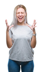 Wall Mural - Young blonde woman over isolated background celebrating mad and crazy for success with arms raised and closed eyes screaming excited. Winner concept