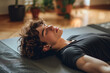 © ArtCraft - Relaxed young woman practicing yoga. A peaceful and calming scene showcasing relaxation and mindfulness. Ideal for wellness, mental health, or fitness content.