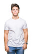 © Krakenimages.com - Young handsome man wearing white t-shirt over isolated background Relaxed with serious expression on face. Simple and natural looking at the camera.