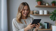 © New generate - Happy relaxed young woman standing in home office using tablet, excited lady laughing holding tablet, enjoying doing online ecommerce shopping in mobile apps